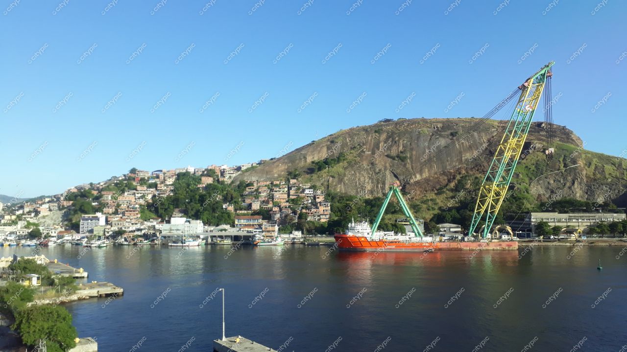 Niterói, Rio de Janeiro: Vista panorâmica do porto com navio laranja e morro verde ao fundo