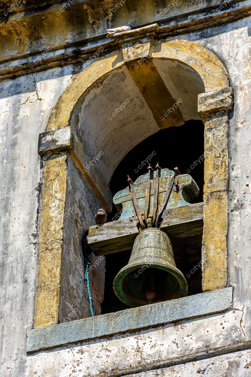 Ouro Preto, Minas Gerais: Sino antigo em janela de igreja histórica – Reflexos do patrimônio colonial brasileiro