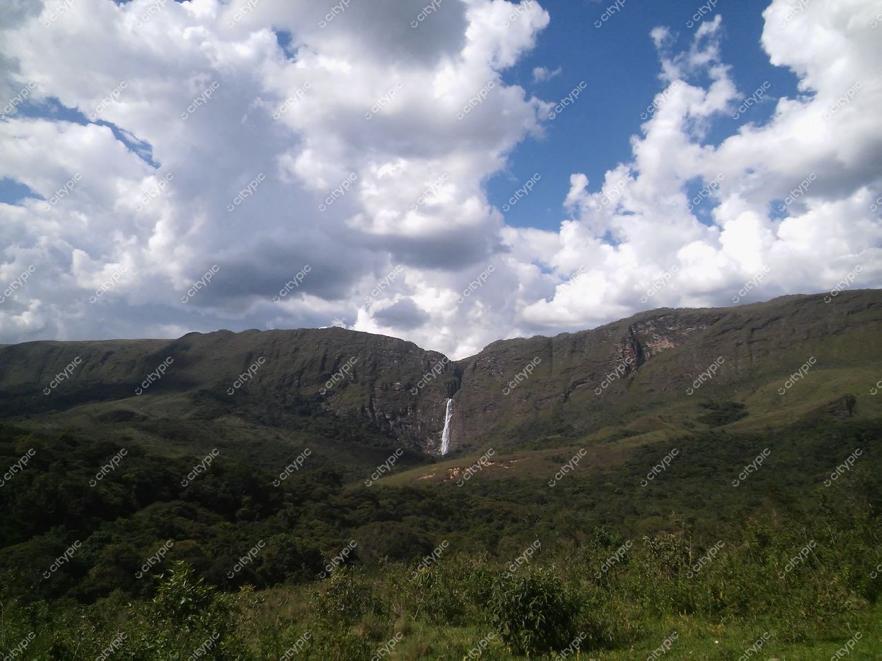Serra da Canastra, Minas Gerais, vista de relevo montanhoso com cascata e céu azul em dia claro