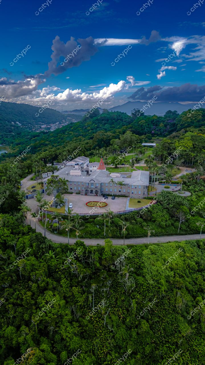 Morro das Pedras e Lagoa do Peri em Florianópolis com vista aérea de propriedade cercada por vegetação densa e céu azul