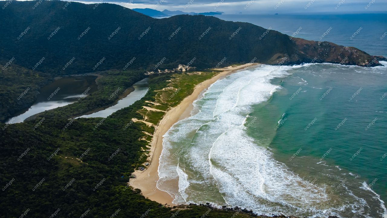 Lagoinha do Leste em Florianópolis com vista aérea em dia nublado e vegetação verdejante ao fundo