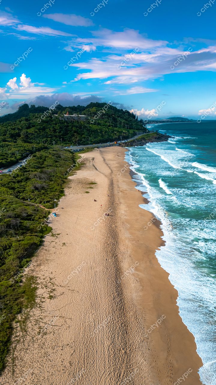 Morro das Pedras e Lagoa do Peri em Florianópolis com faixa de areia clara e vegetação densa ao redor