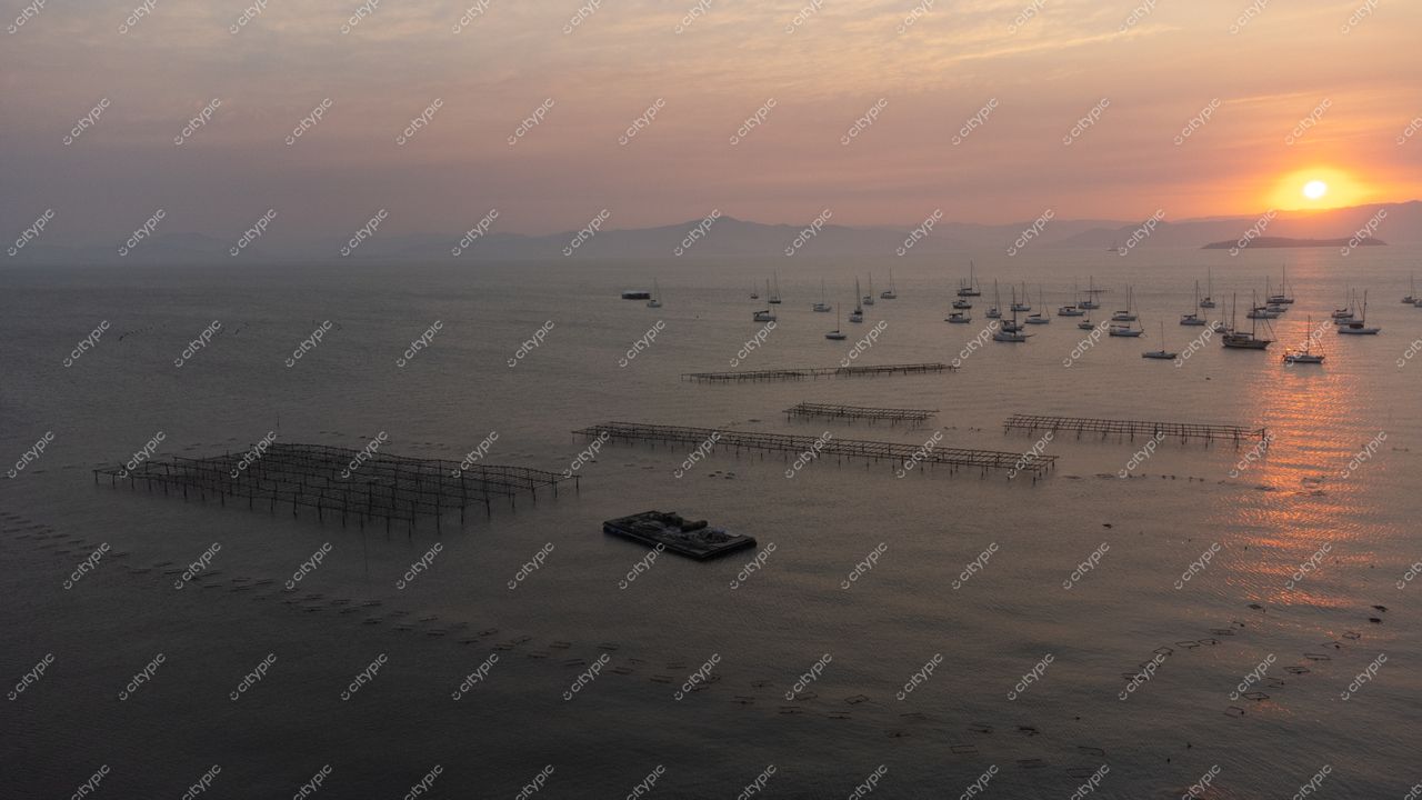 Florianópolis, Santa Catarina vista aérea do pôr do sol com embarcações ancoradas e estruturas de cultivo no mar