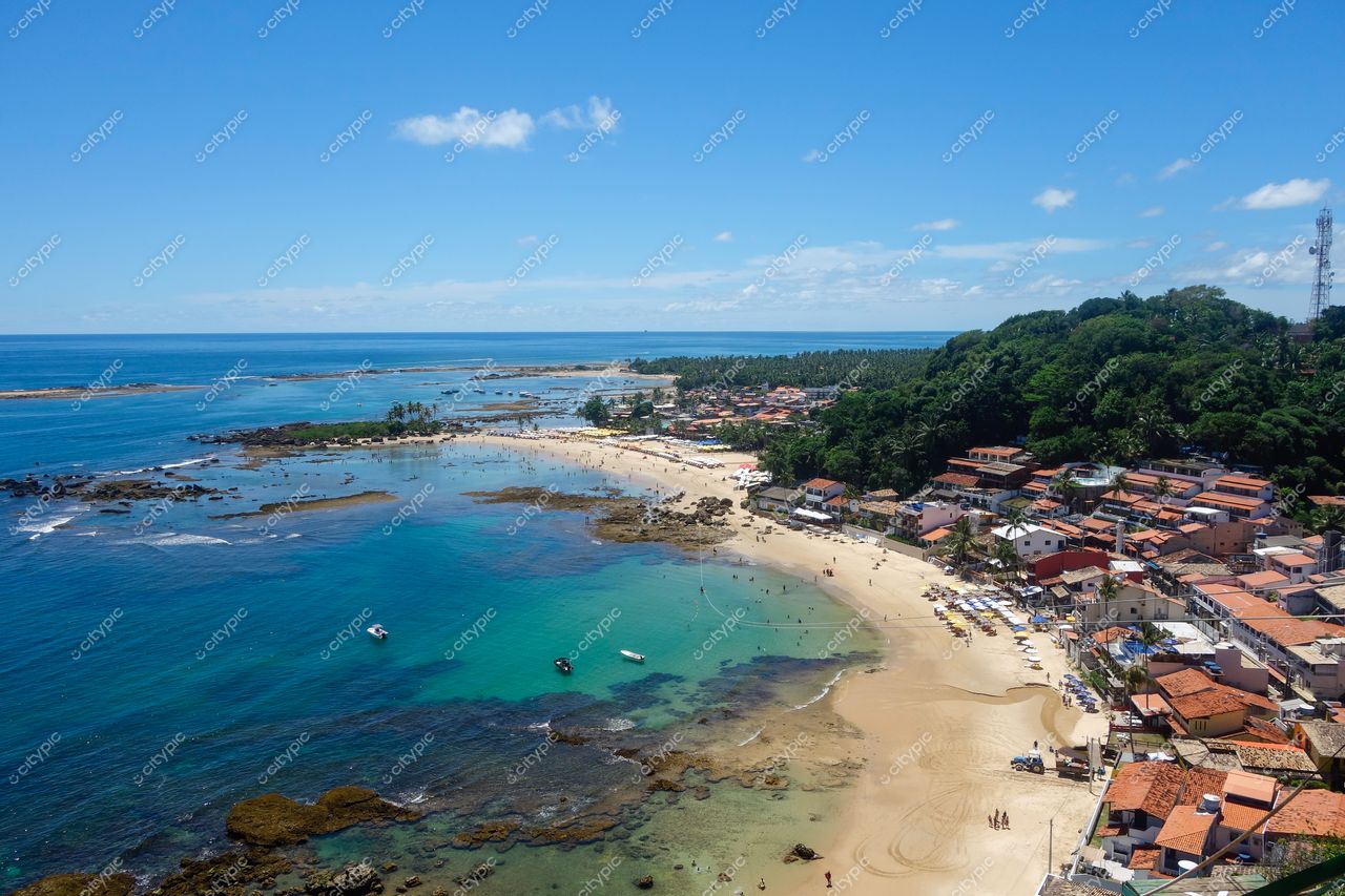Morro de São Paulo, Bahia, vista panorâmica com praia clara, casas coloridas e vegetação densa sob céu ensolarado