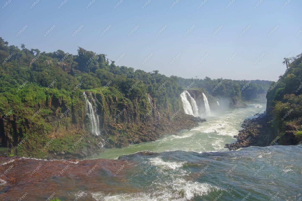 Foz do Iguaçu, Paraná vista panorâmica das Cataratas com luz solar intensa e vegetação densa ao redor