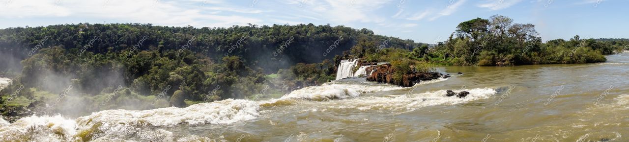 Foz do Iguaçu, Paraná vista panorâmica das Cataratas com vegetação densa e céu azul em dia claro
