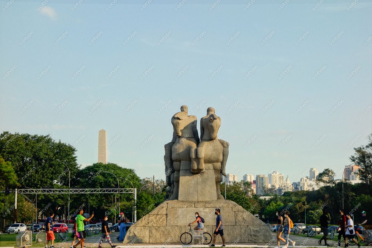 São Paulo, São Paulo escultura de figuras humanas em espaço aberto com vegetação e edifícios sob céu limpo diurno