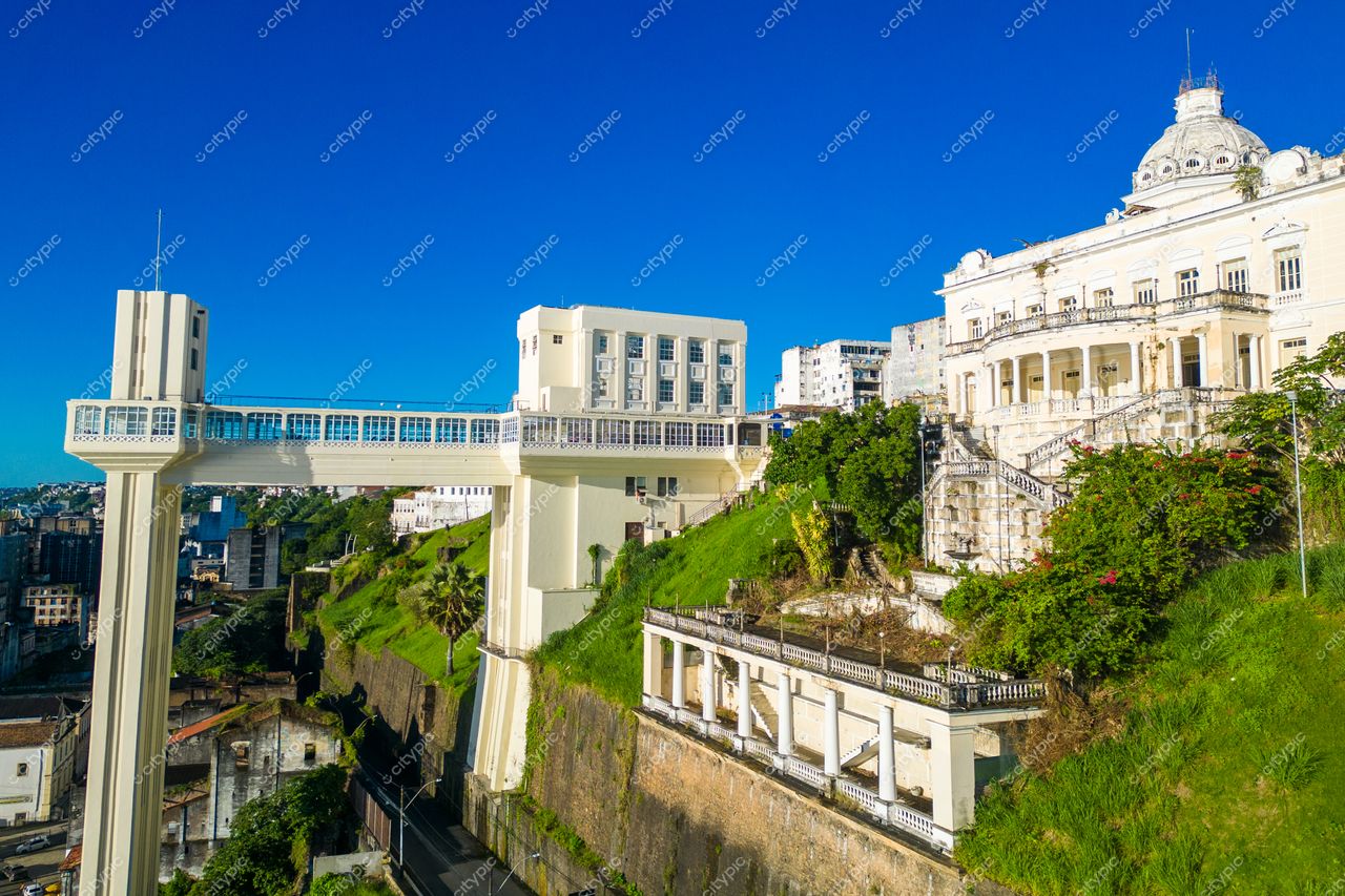 Salvador, Bahia, Elevador Lacerda em dia ensolarado com vegetação verde e arquitetura histórica ao fundo