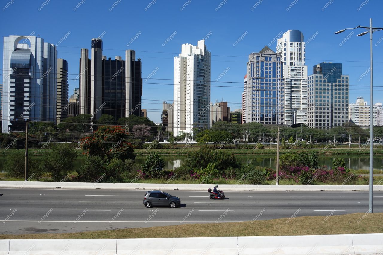 São Paulo, São Paulo, vista urbana com edifícios modernos, via expressa movimentada e áreas verdes ao redor de um lago