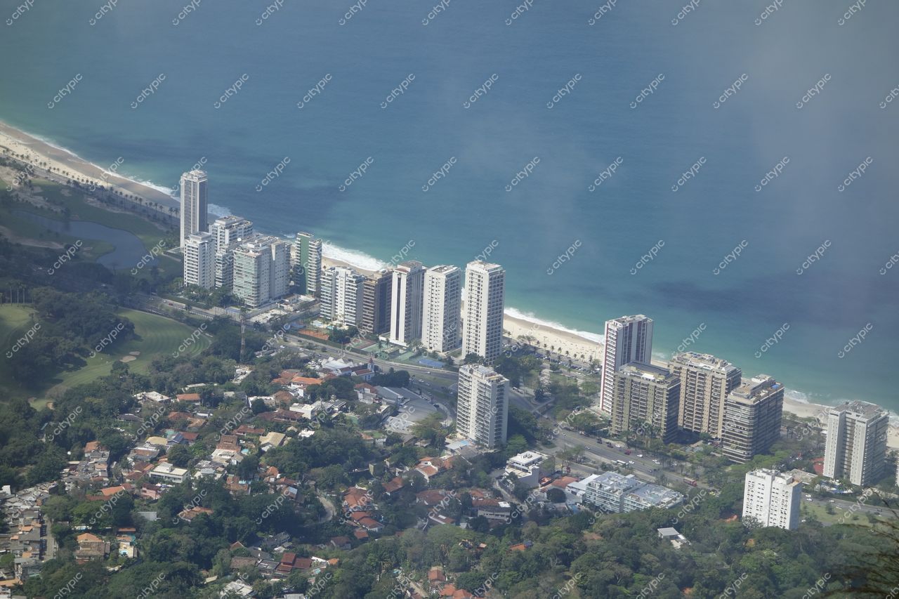 Rio de Janeiro, Rio de Janeiro vista aérea da costa com edifícios urbanos, vegetação e mar em dia ensolarado
