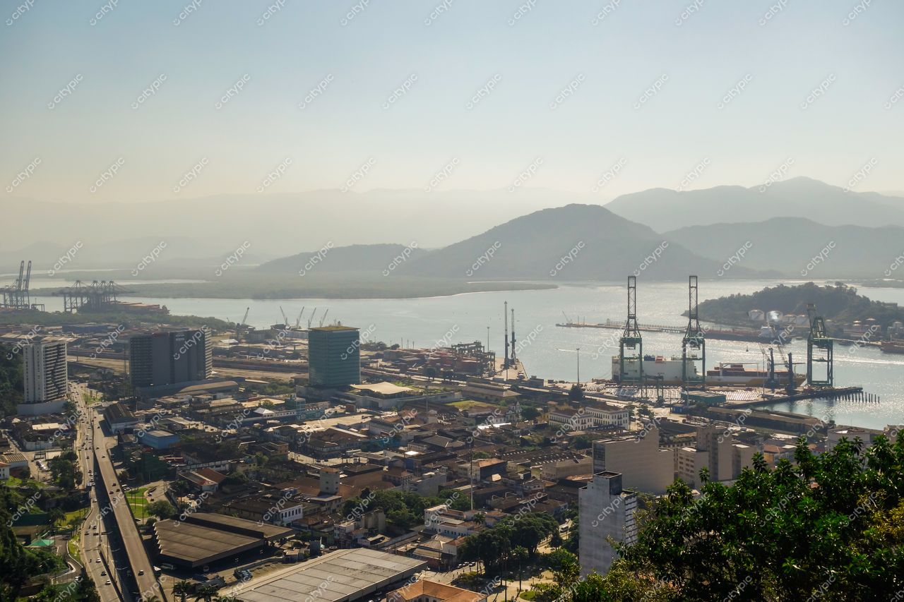 Santos, São Paulo, vista panorâmica do Porto com guindastes, edifícios modernos e montanhas ao fundo pela manhã