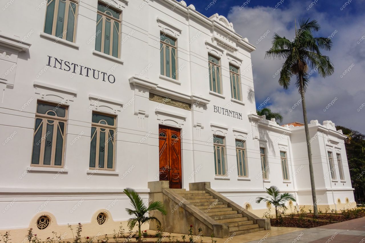 São Paulo, São Paulo, fachada neoclássica do Instituto Butantan com plantas ornamentais sob céu parcialmente nublado