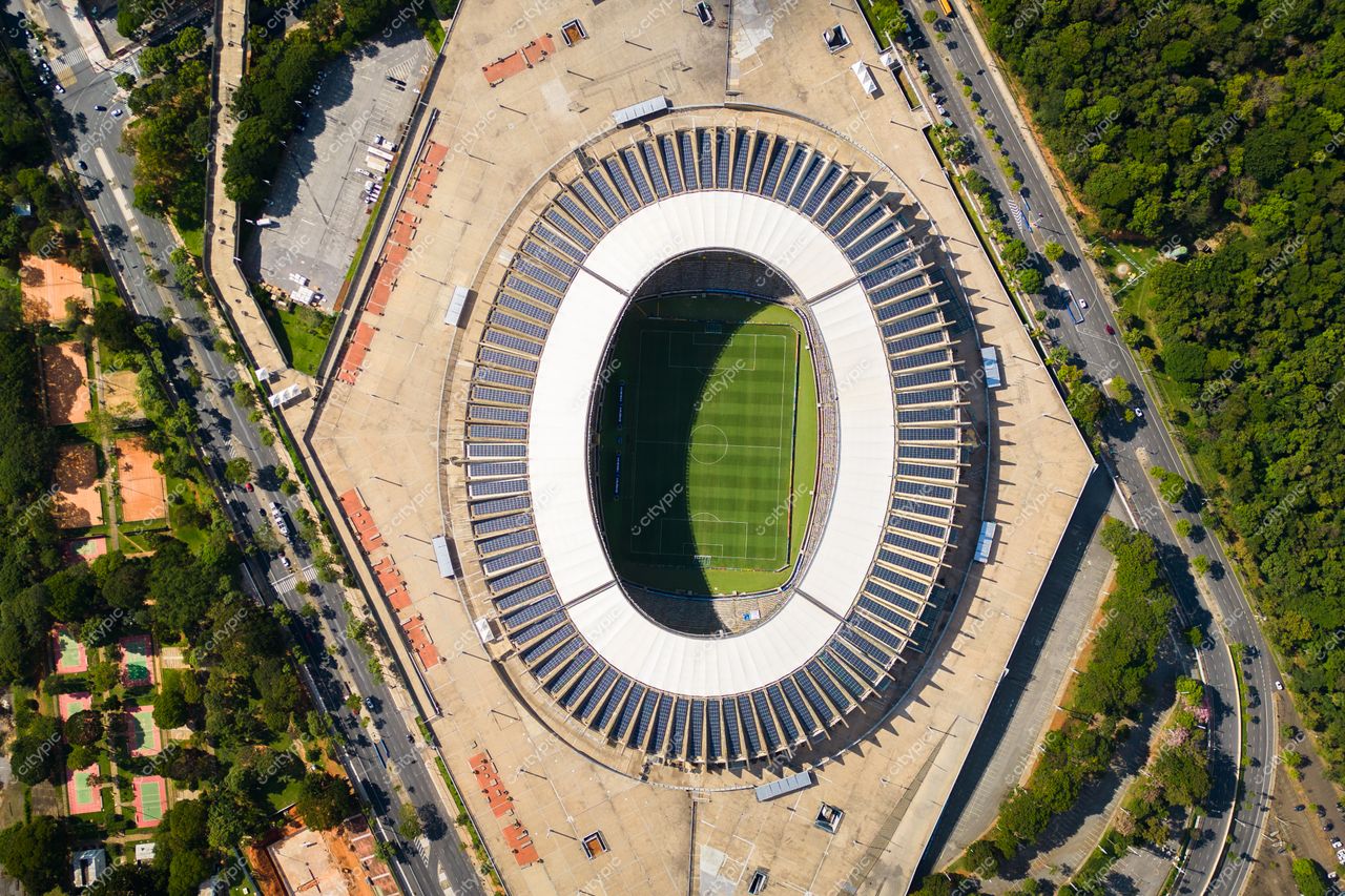 Belo Horizonte, Minas Gerais, imagem aérea de estádio ovalado com vegetação ao redor e tráfego leve durante o dia