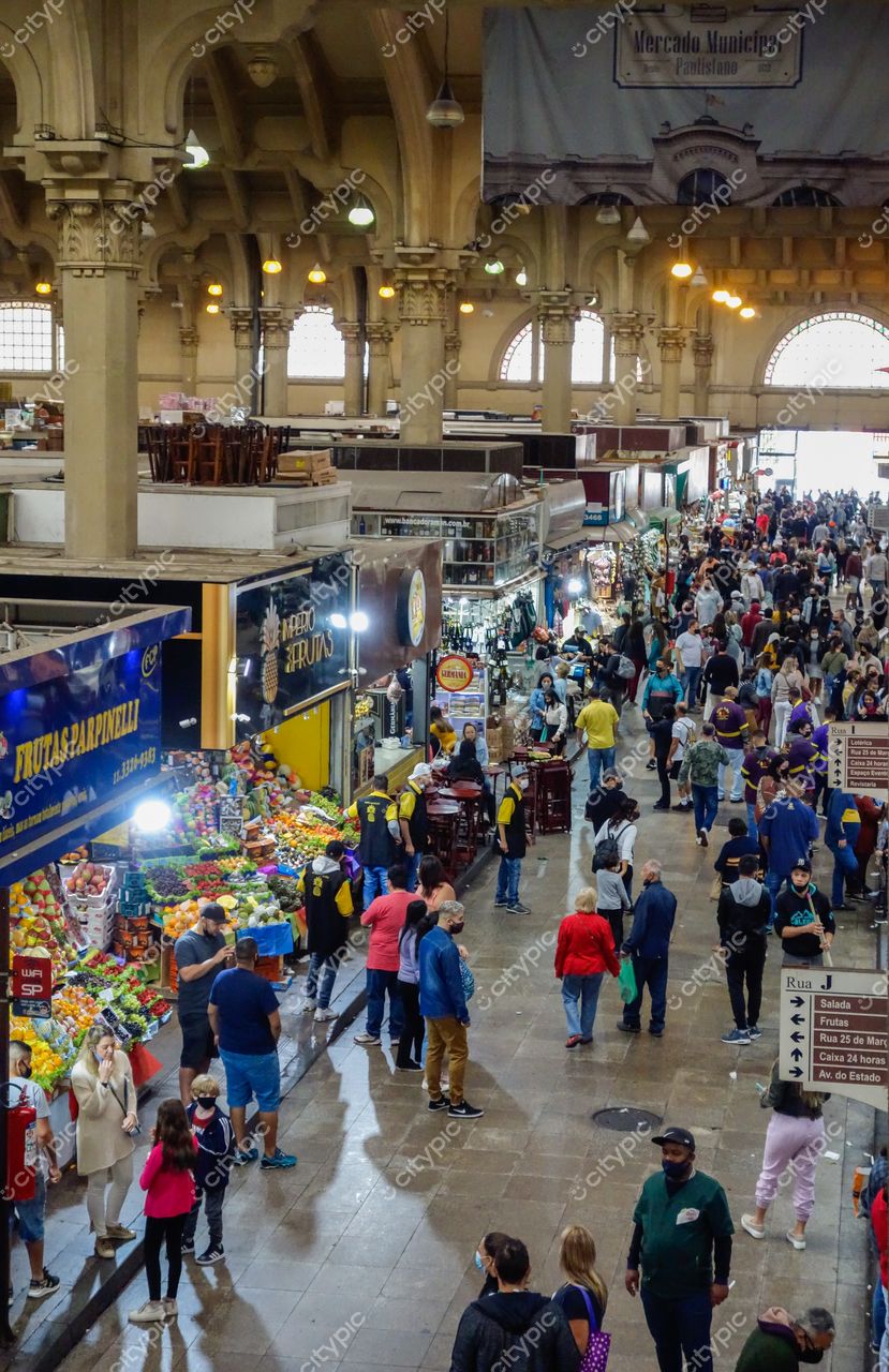 Mercado Municipal de São Paulo em São Paulo com luz natural destacando a arquitetura e o movimento vibrante de pessoas