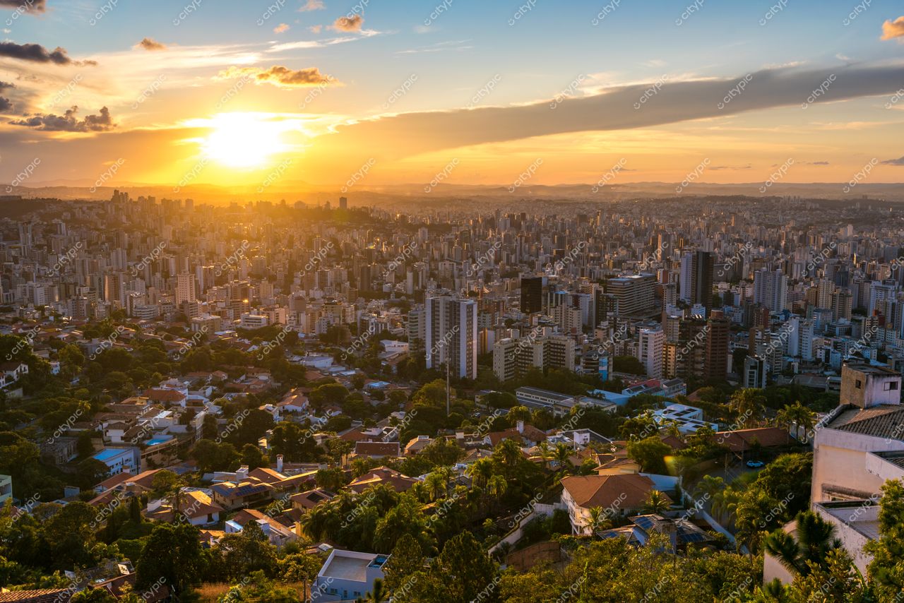 Belo Horizonte, Minas Gerais, vista panorâmica ao pôr do sol com edifícios altos e áreas verdes intercaladas