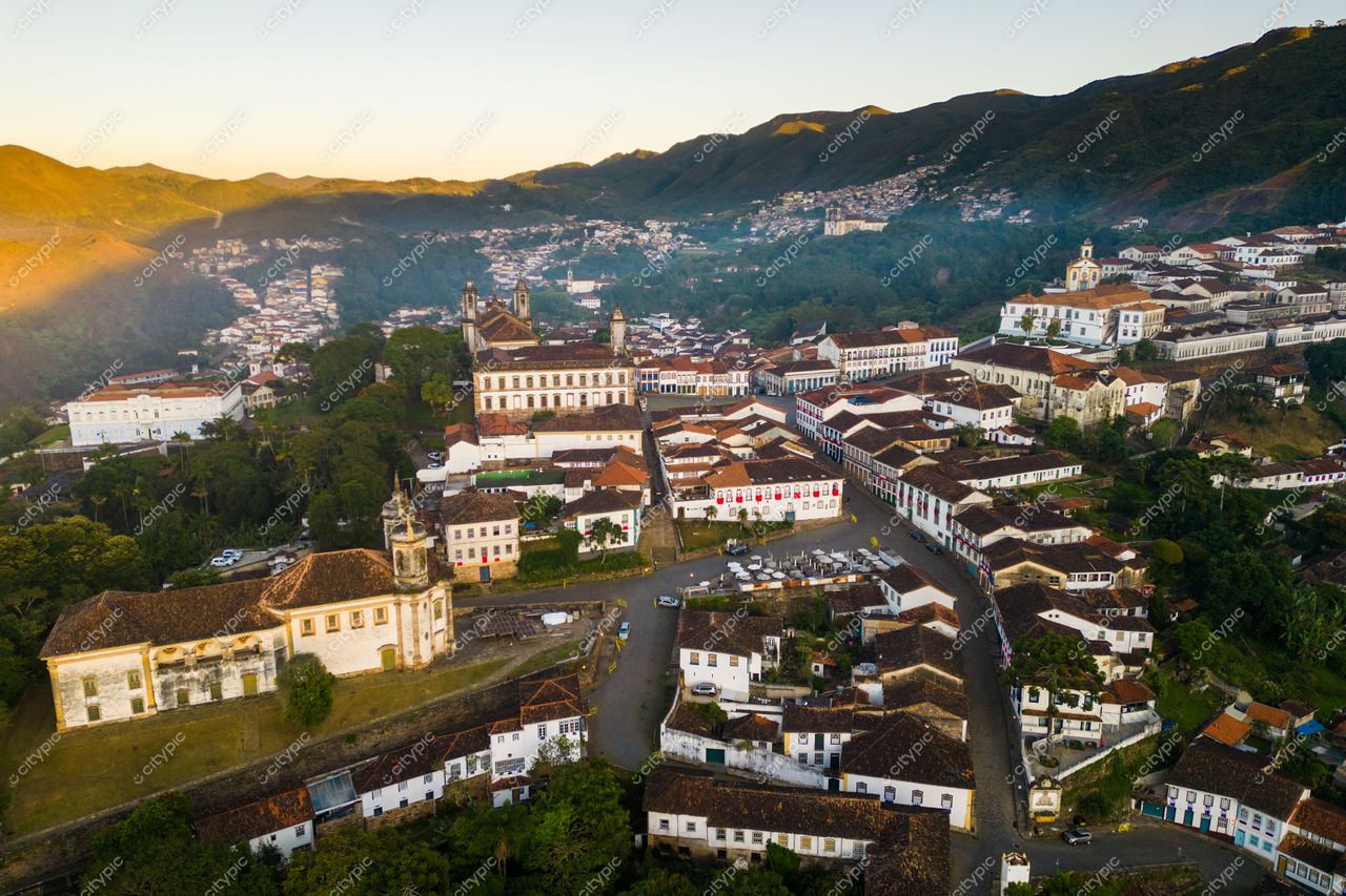 Ouro Preto, Minas Gerais vista aérea ao amanhecer com arquitetura colonial e vegetação exuberante em montanhas ao fundo