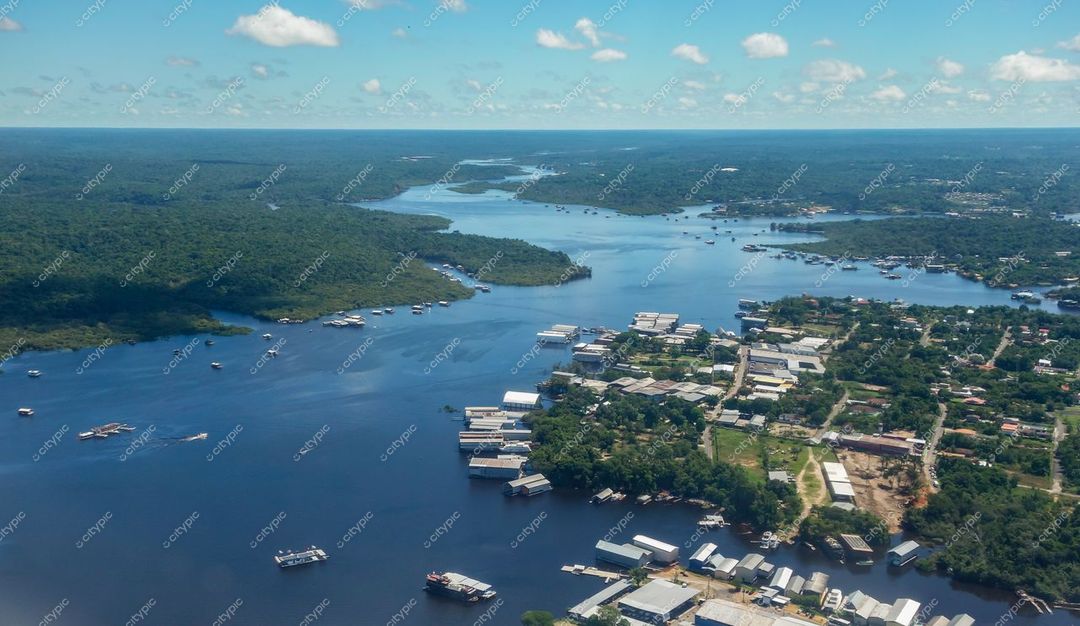 Manaus, Amazonas com vegetação tropical e cursos d’água sob luz natural em dia ensolarado e urbanização à margem do rio